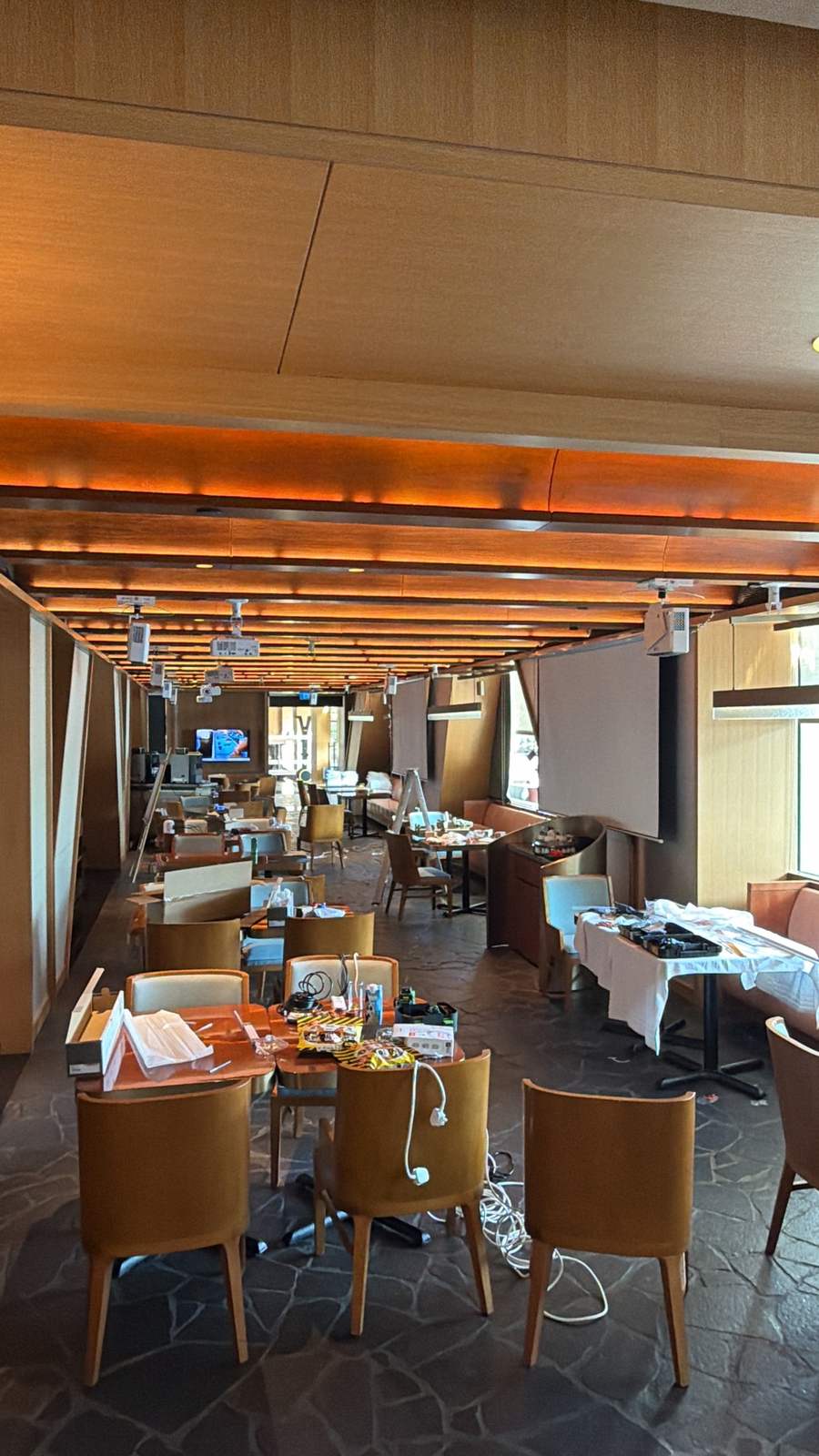 A restaurant by day, ceiling beams and screens, before its evening